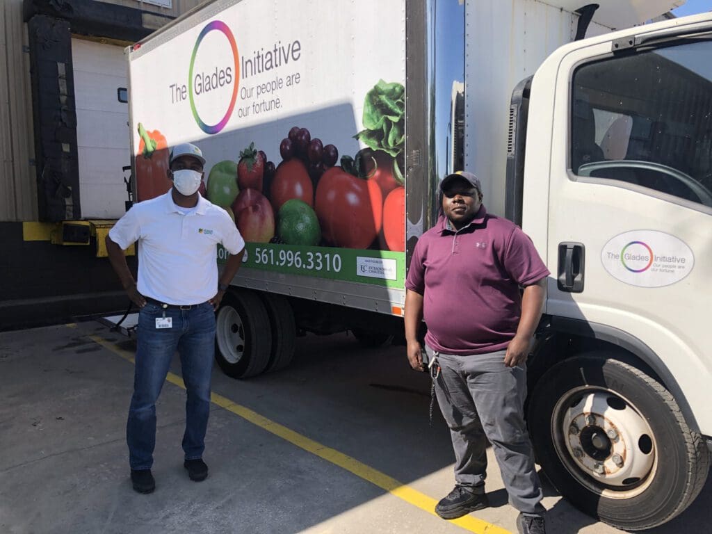 Two people next to truck for Glades Initiative