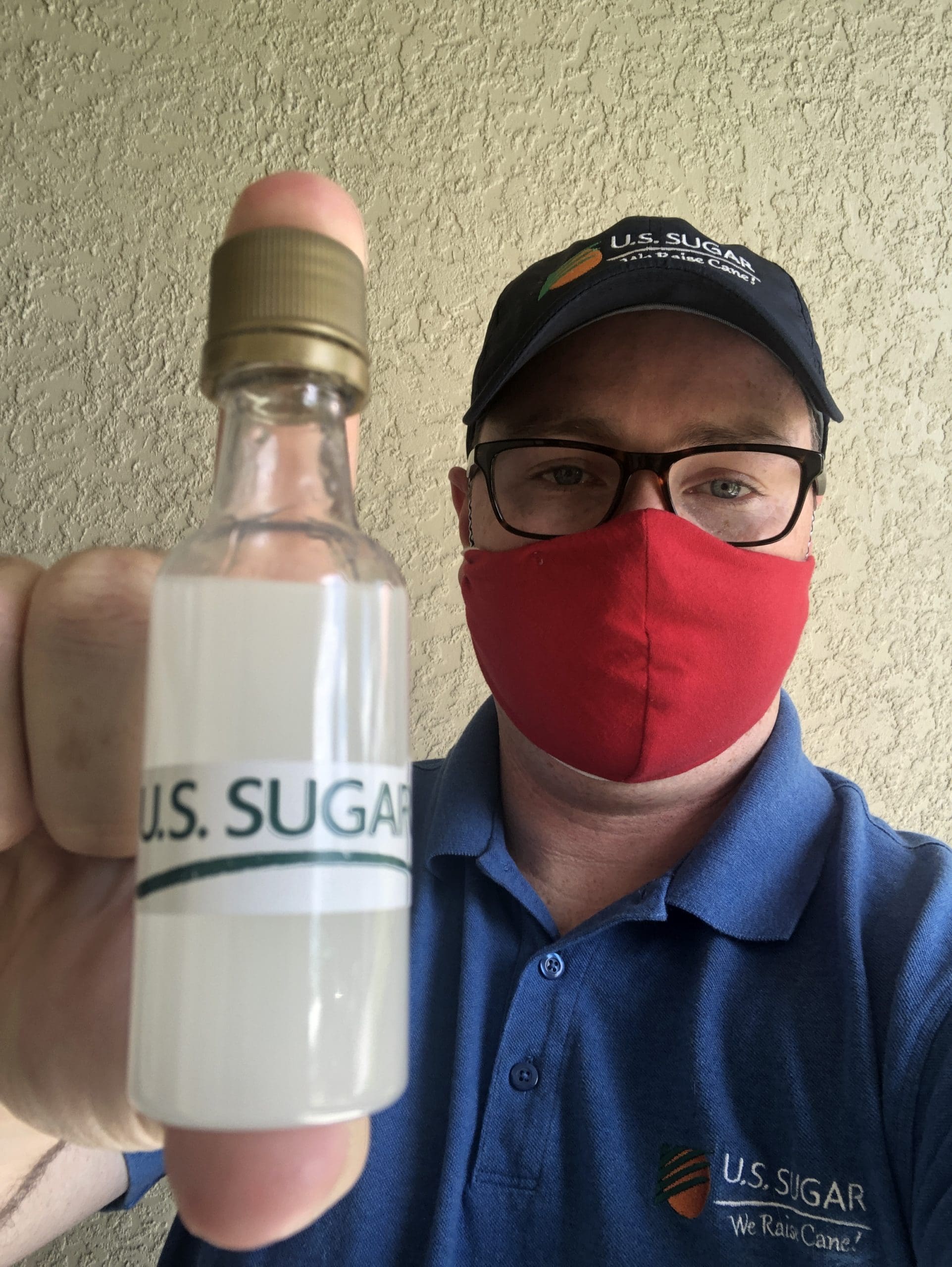 Man posing with small bottle of hand sanitizer