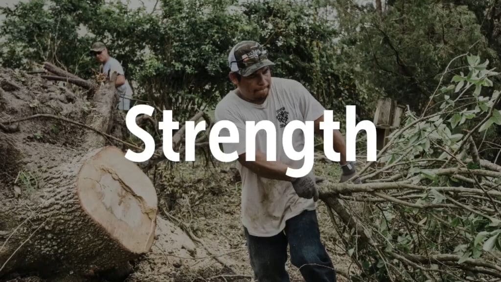 Man with tree limb and word strength