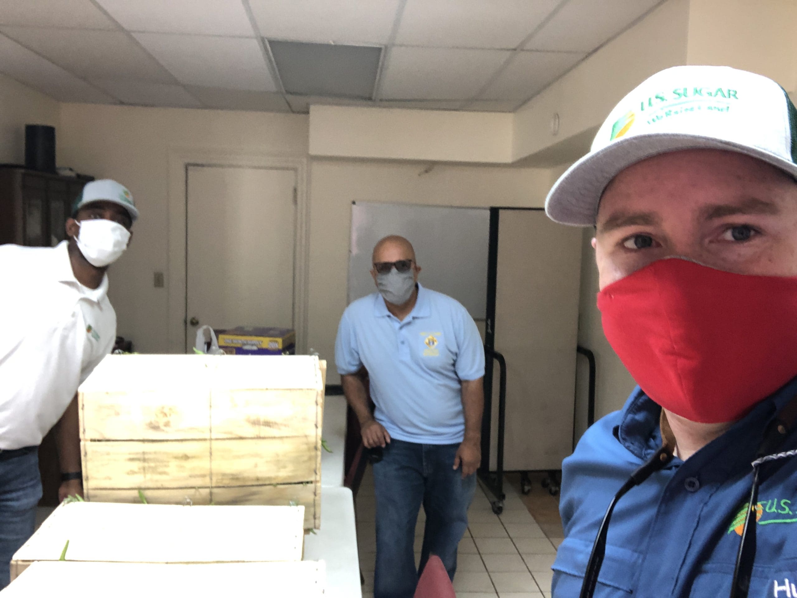 men posing with packed box 