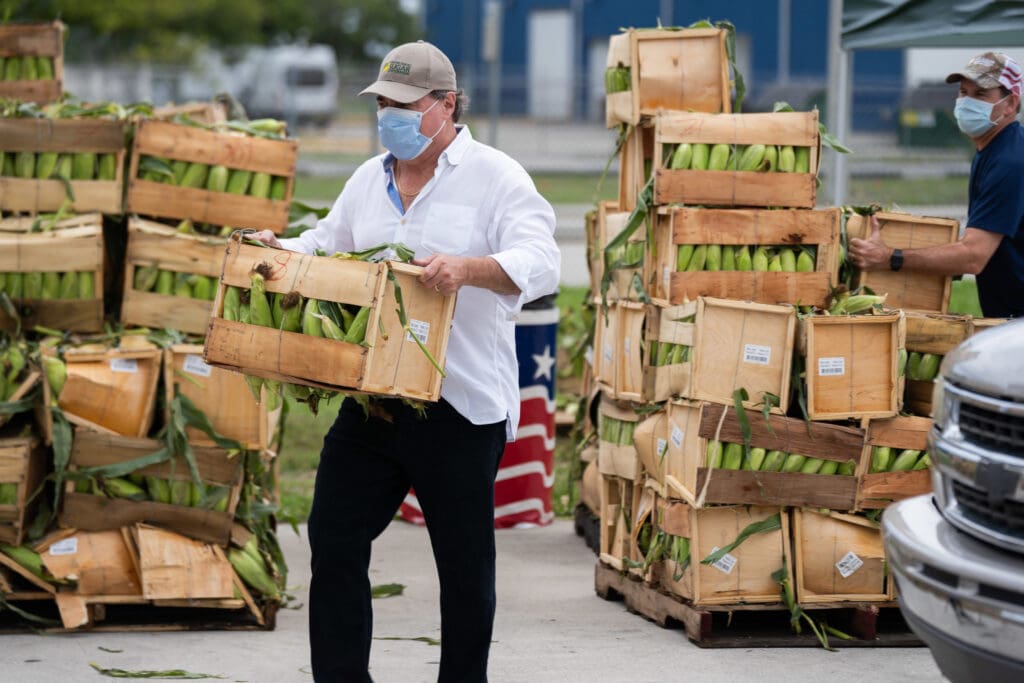 Woman carrying sweet corn