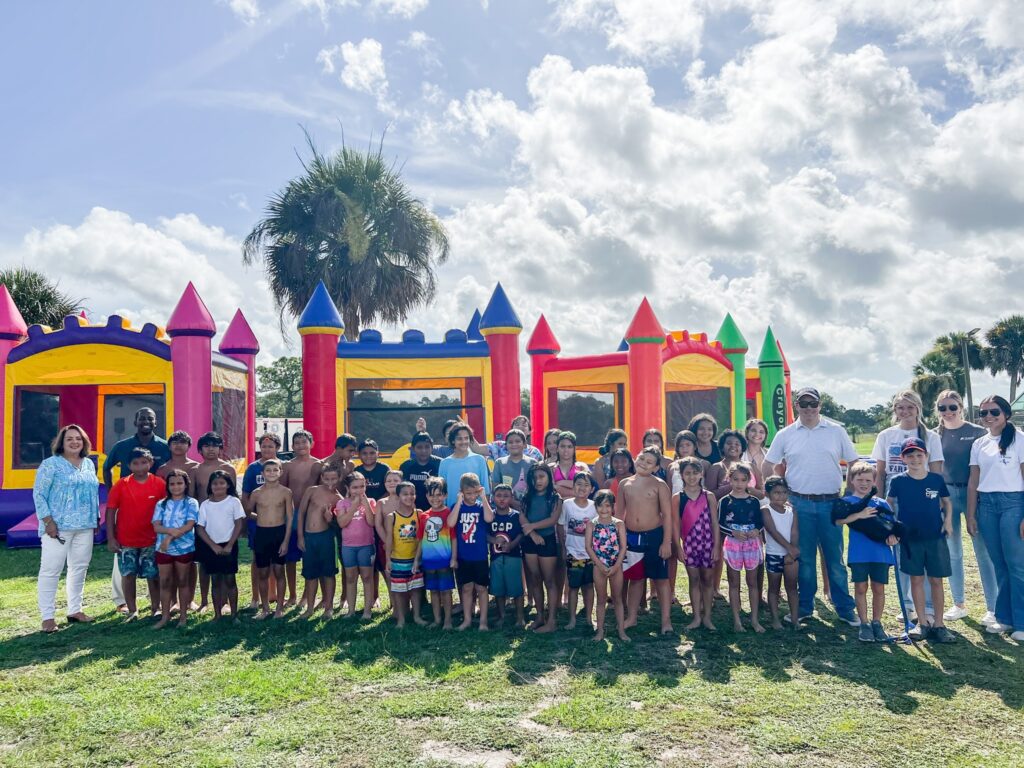 U.S. Sugar leaders Brannan Thomas, Ryan Duffy and Elaine Wood join Montura leaders and children for field day at Montura Summer camp at the Montura Club House.