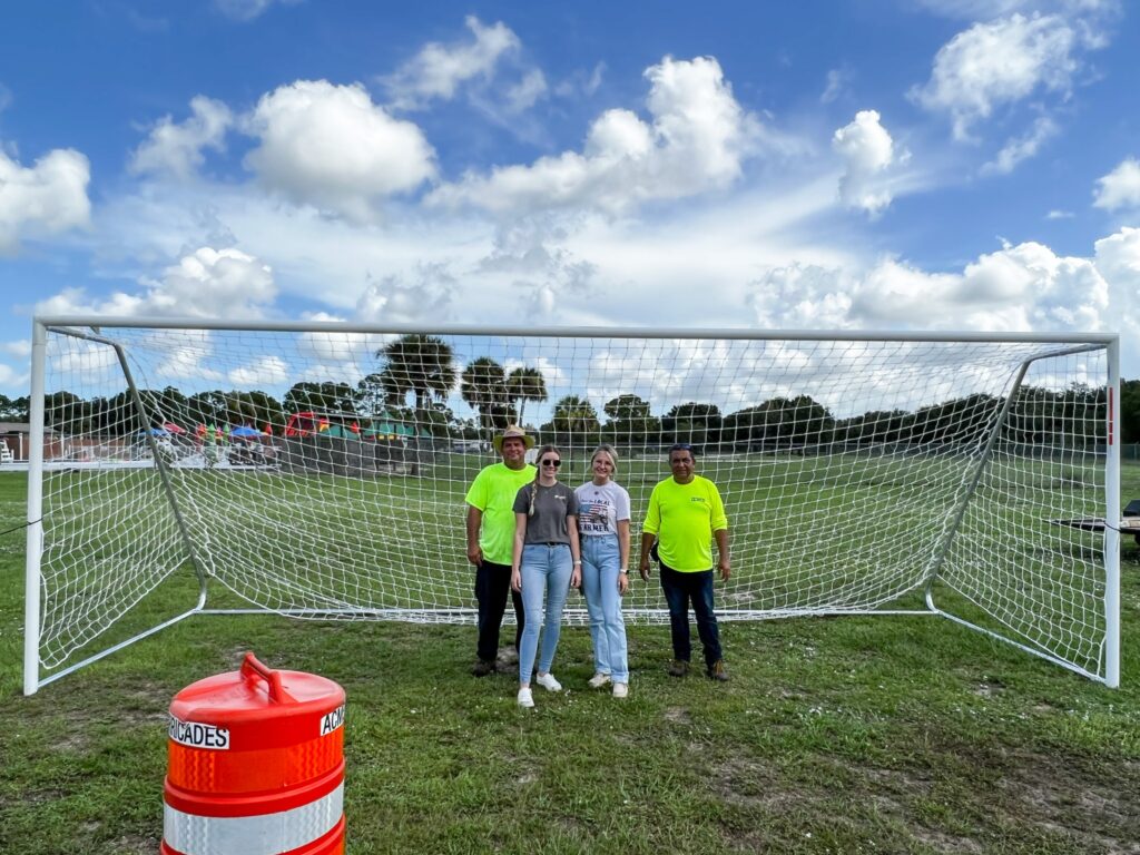 U.S. Sugar interns Camber Pope and Kalei Sutton join Montura community leaders for delivery of new soccer goals provided by the people of U.S. Sugar