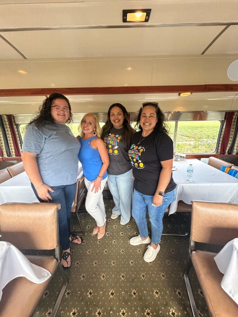 women posing for photo inside a train