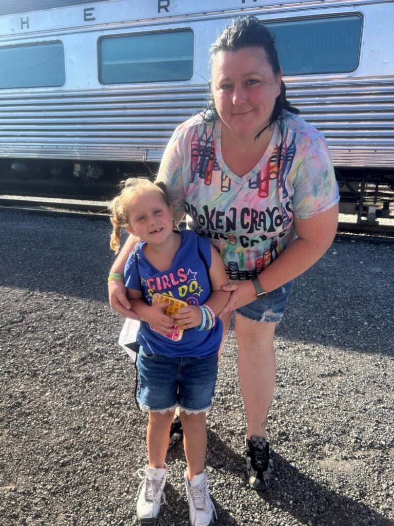 women and child posing for photo