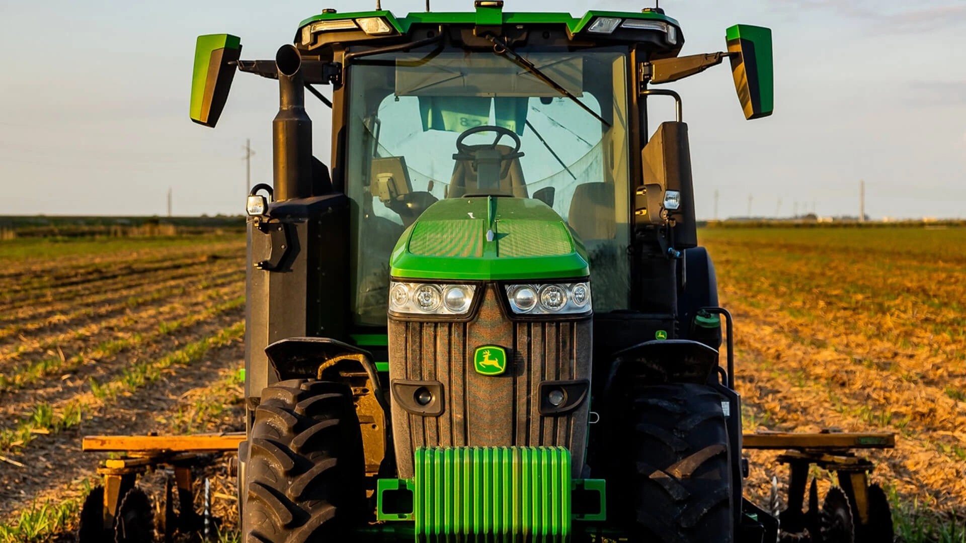 Green John Deere tractor in field