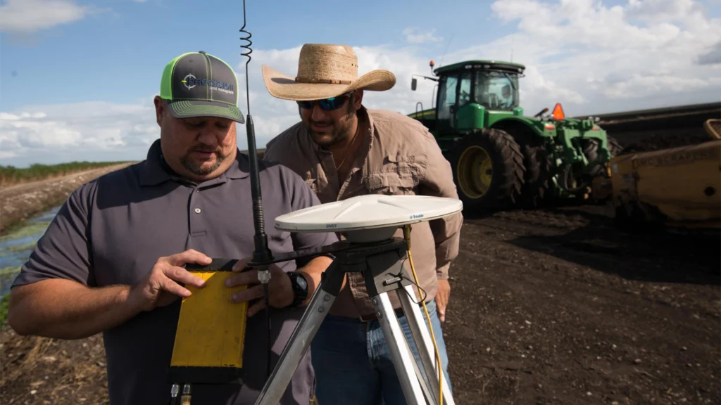 Employees performing laser land leveling - an agriculture technology innovation