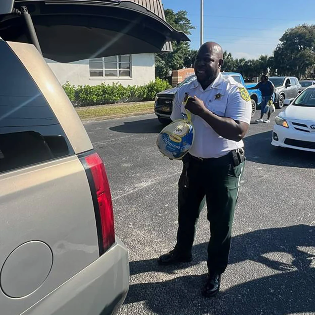 Lt. Everton Morgan distributed turkeys to seniors at the Harlem Senior Center.