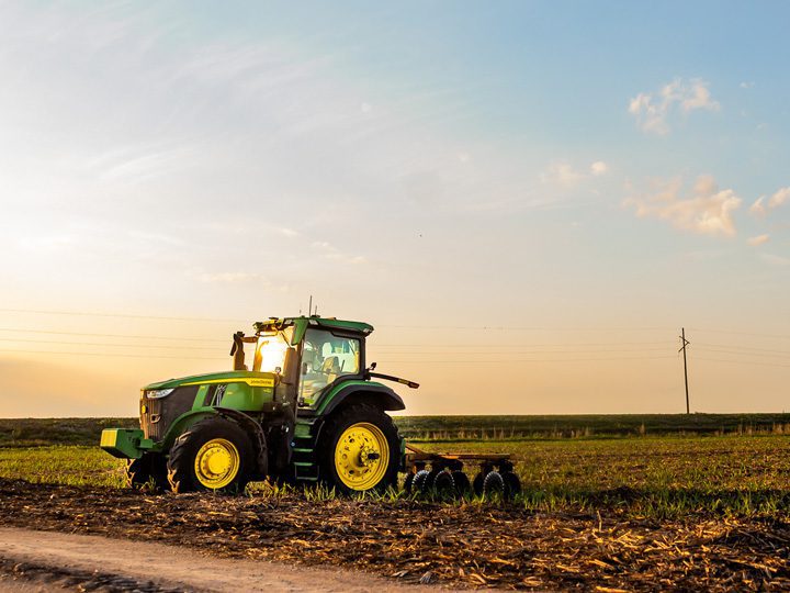Sugarcane tractor harvesting crops in South Florida farmland, demonstrating agriculture’s economic impact and role in rural economic development as a leading agriculture employer in Florida