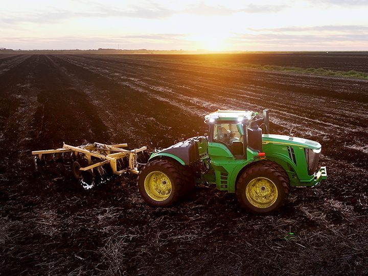 A tractor prepares a sugarcane field at sunrise as part of domestic food production in South Florida.